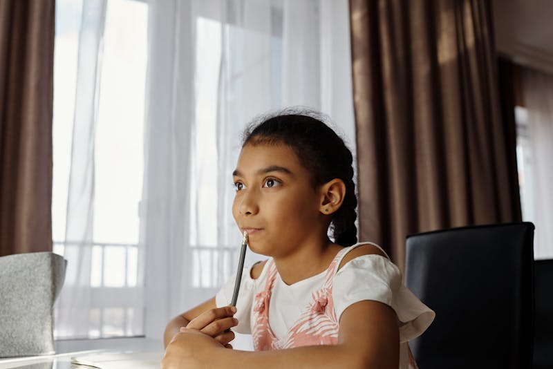 Child thinking at desk